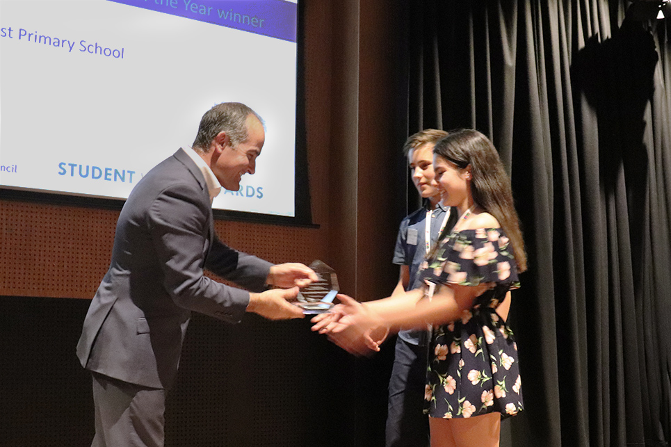 Two students are presented with a Student Voice Award by the Minister for Education